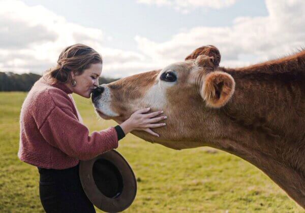 Katie White Kissing a cow on the nose