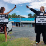 PETA supporters wearing formal clothes and drinking champagne at Dolphin Marine Conservation Park.