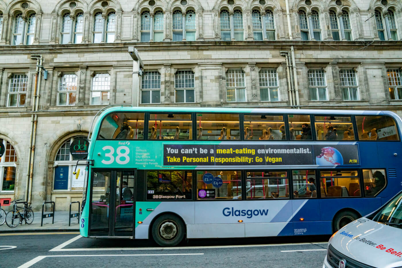 A bus in Glasgow with a PETA UK ad which reads "You can't be a meat-eating environmentalist. Take Personal Responsibility: Go Vegan."