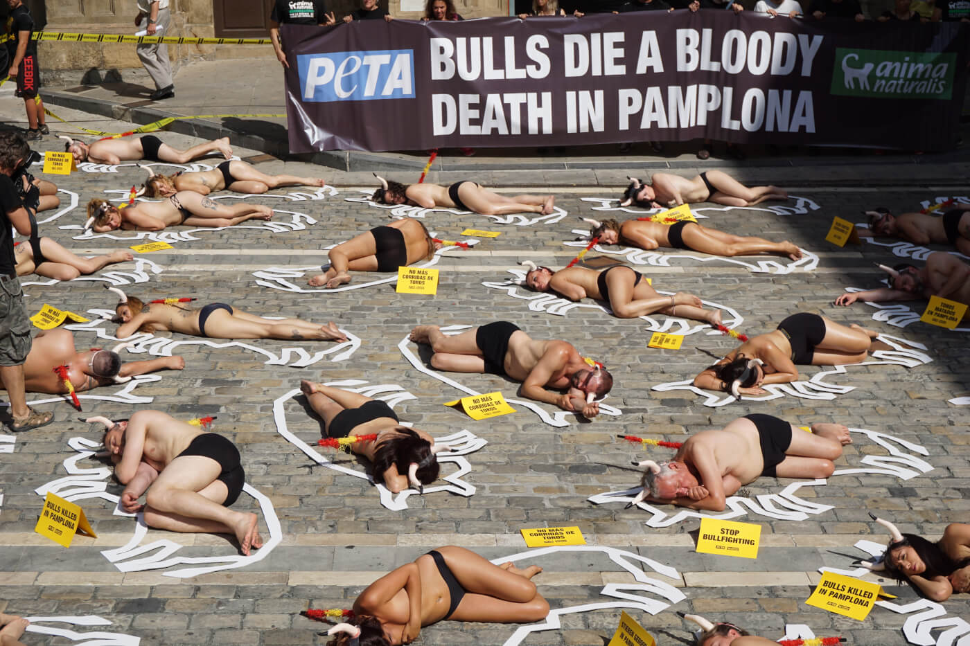 54 protestors staged a “crime scene” cordoned off with yellow tape in Pamplona, Spain, to call to end the annual torture and killing of the bulls.