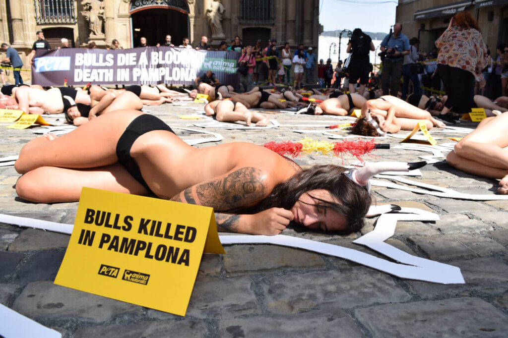 54 protestors staged a “crime scene” cordoned off with yellow tape in Pamplona, Spain, to call to end the annual torture and killing of the bulls.