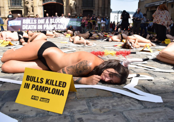 54 protestors staged a “crime scene” cordoned off with yellow tape in Pamplona, Spain, to call to end the annual torture and killing of the bulls.