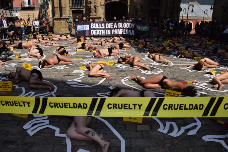 54 protestors staged a “crime scene” cordoned off with yellow tape in Pamplona, Spain, to call to end the annual torture and killing of the bulls.