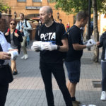 A photo of PETA supporters handing out toilet paper.