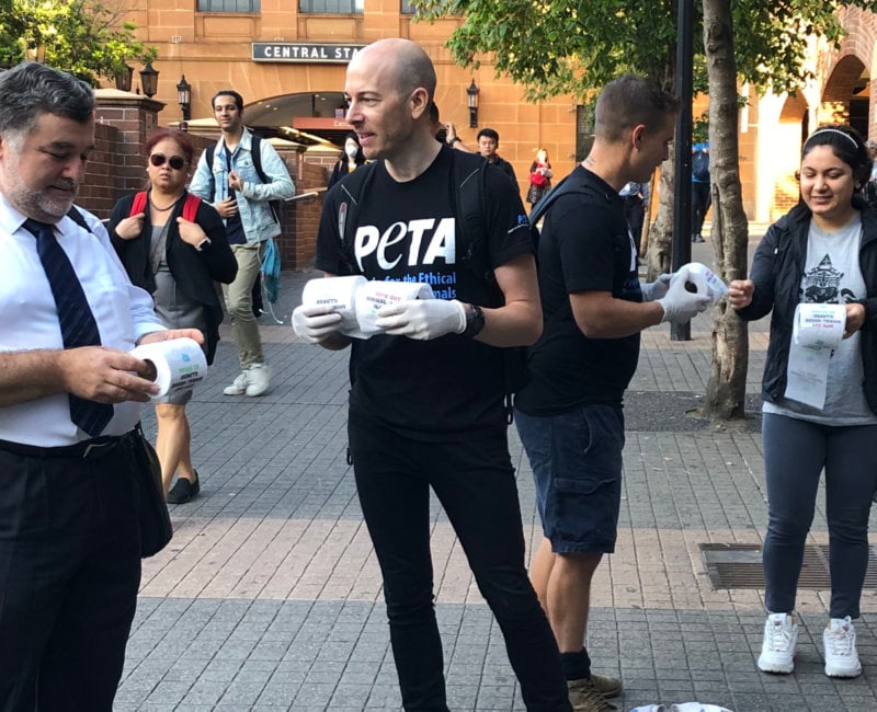 A photo of PETA supporters handing out toilet paper.