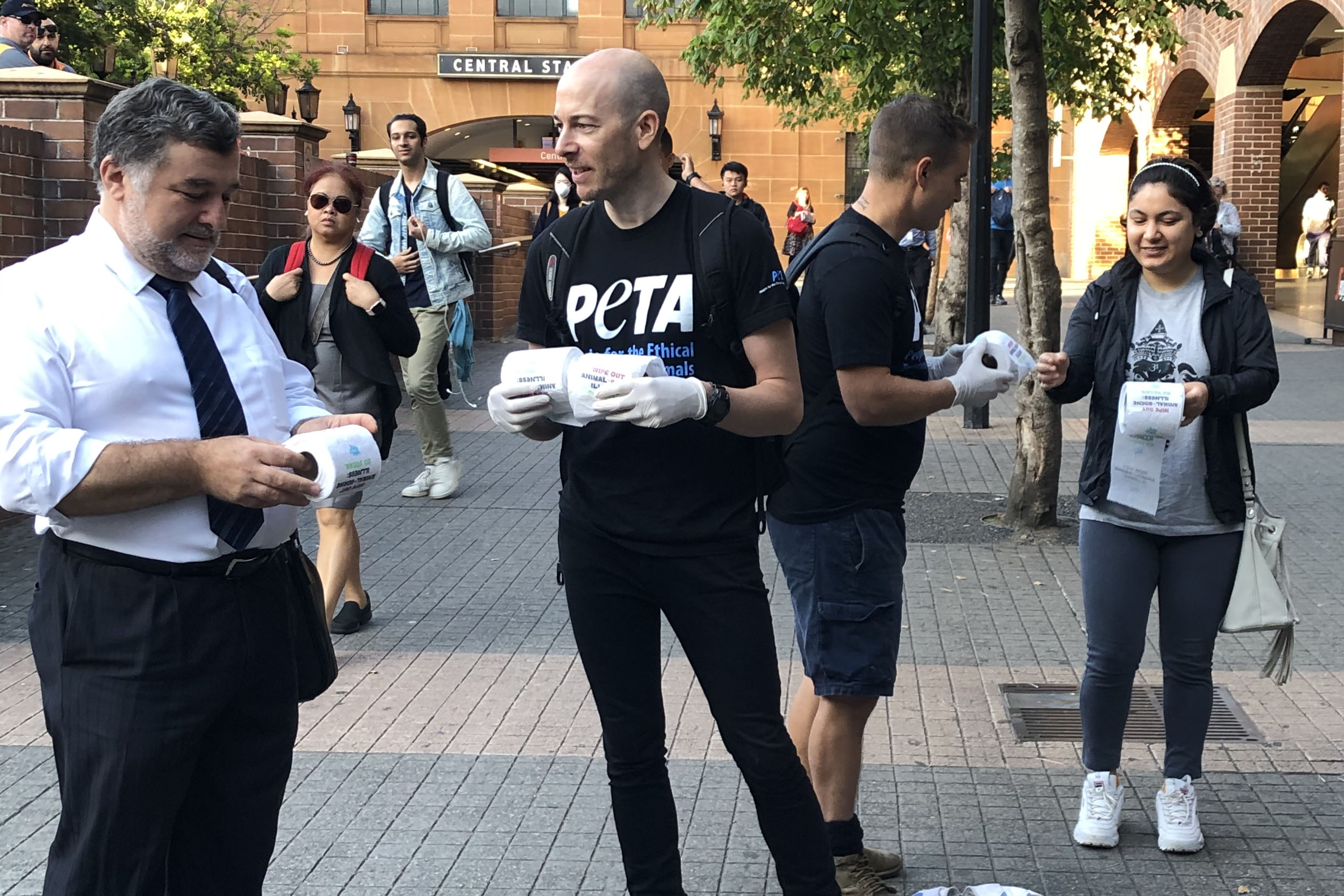 A photo of PETA supporters handing out toilet paper.