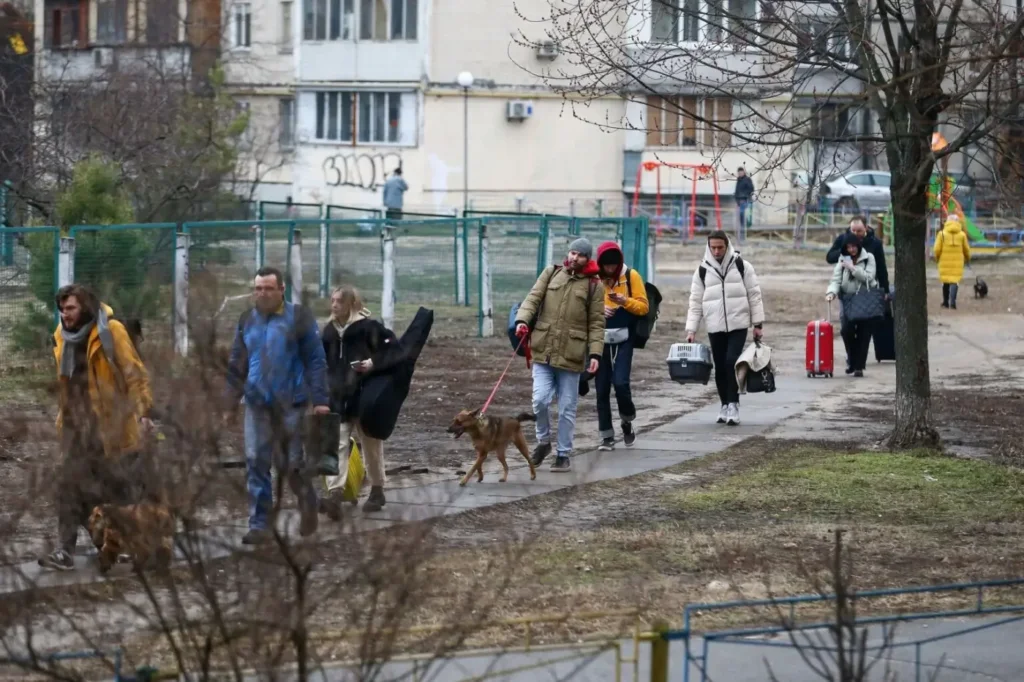People walking with their belongings including animals at Kyiv, Ukraine