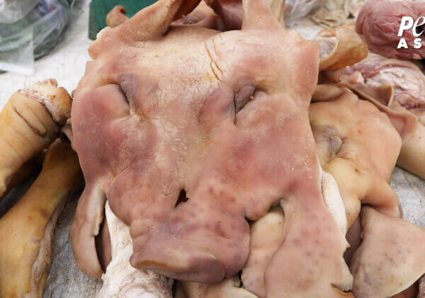 Pigs sold for food at a market.