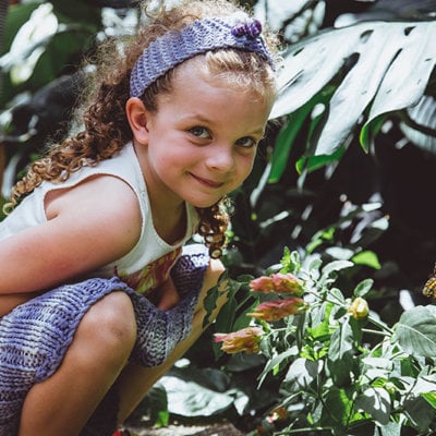 A child with a butterfly in the botanic gardens
