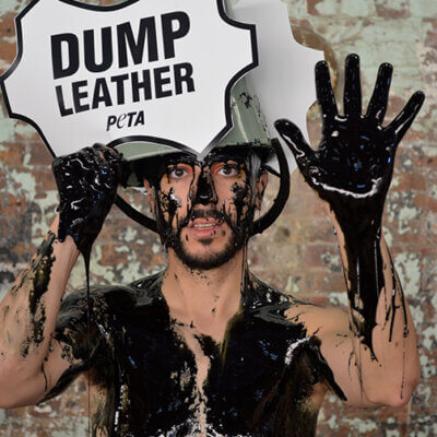 PETA supporters pour buckets of black “toxic slime” – representing the harmful waste generated by the leather industry – over their heads at Fashion Week.