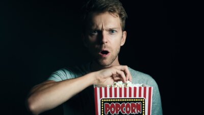 a man eating popcorn.