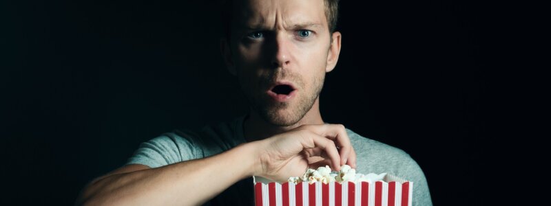 a man eating popcorn.