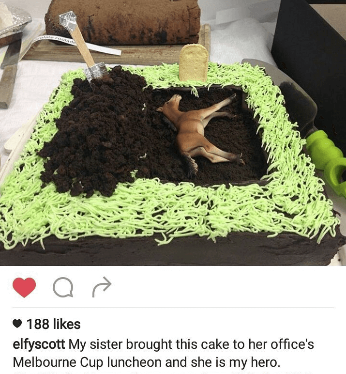 A cake that looks like a grave with a toy horse in it