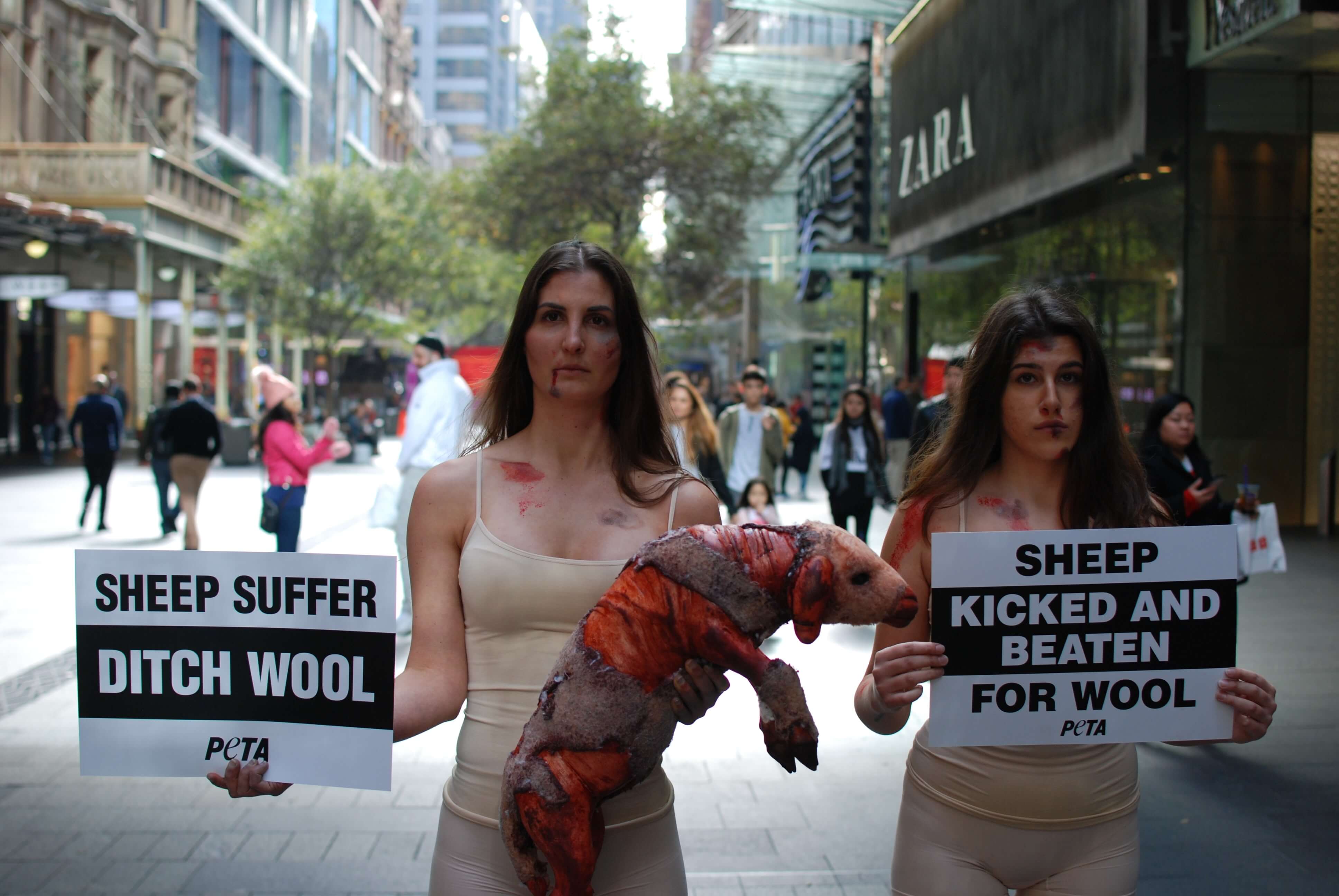 Wool Hurts: PETA Protesters Cradle Shorn ‘Sheep’ in Sydney Mall