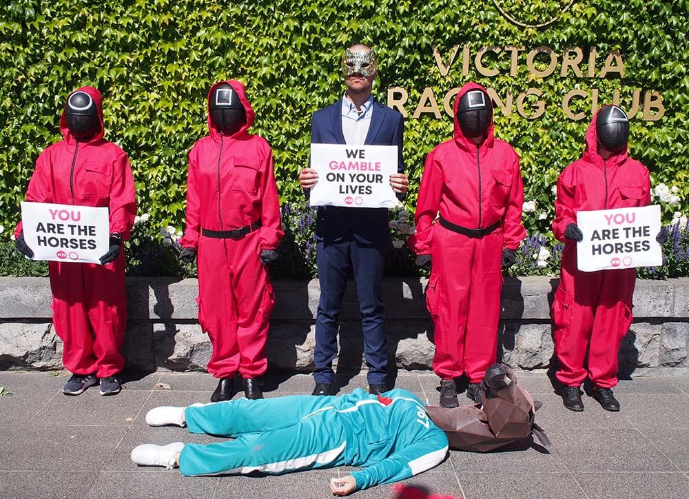 Activists recreate a scene from Squid Game at the gates of Flemington