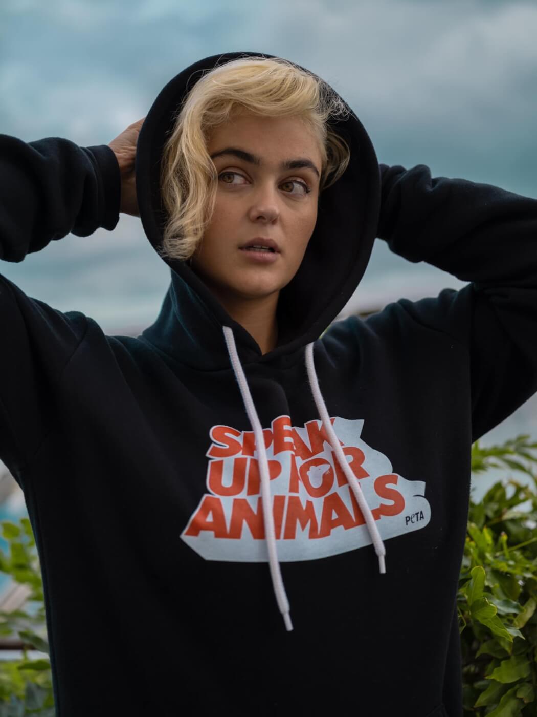 Stefania wears a hoodie that reads "Speak up for animals".