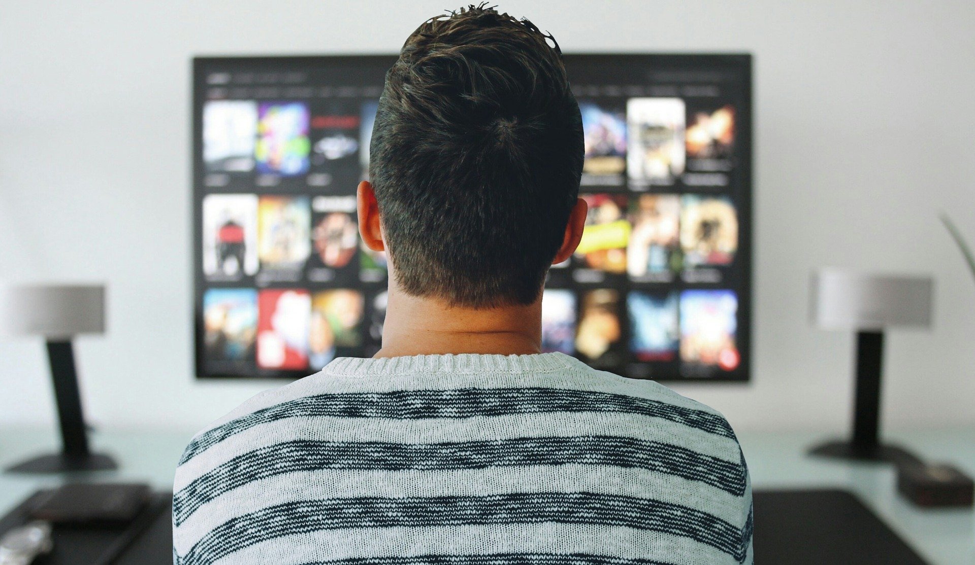 A photo of a person watching television.