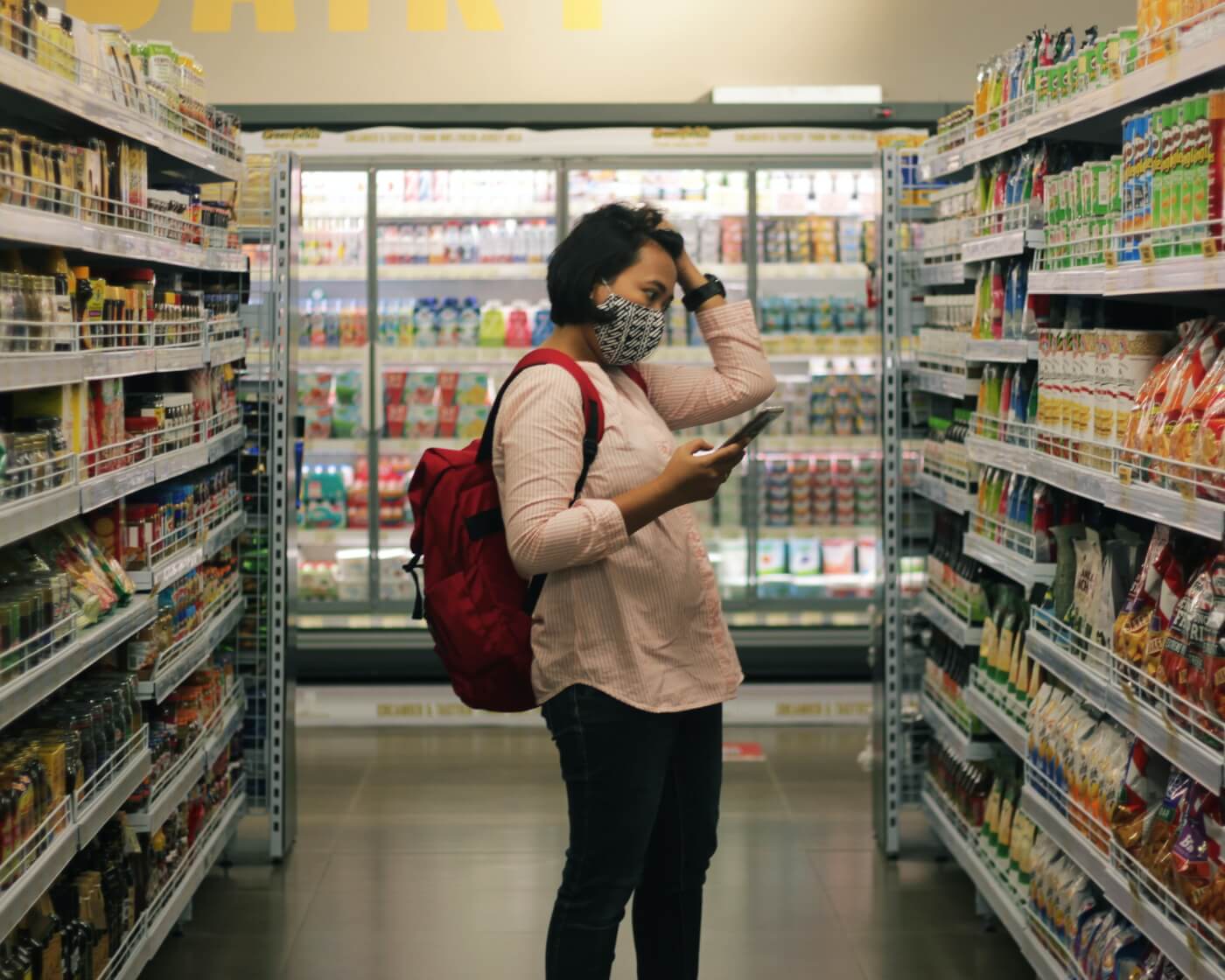 woman browses supermarket shelf