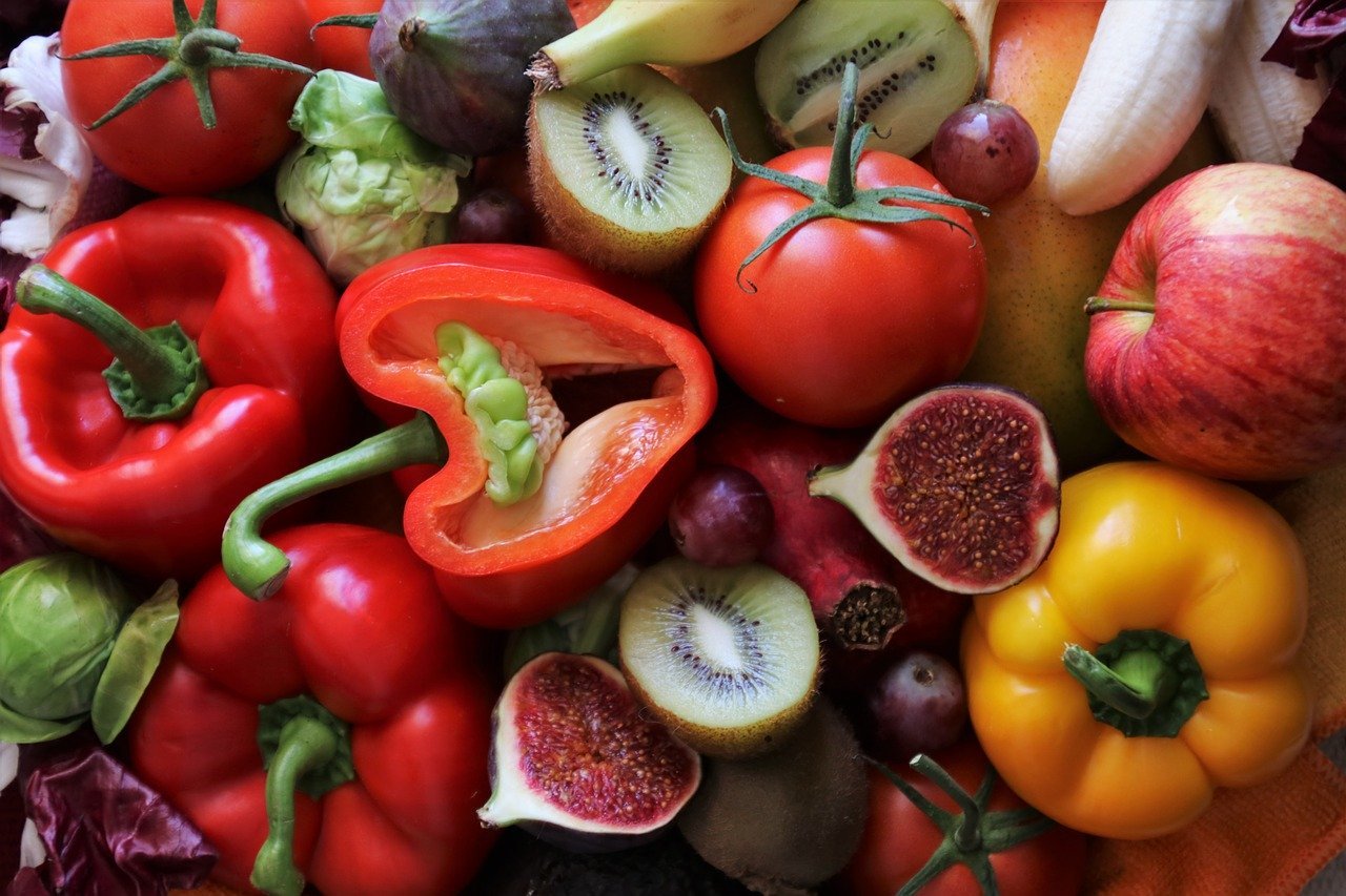 Vitamin C rich foods including capsicum, kiwi fruit, tomato citrus fruits.