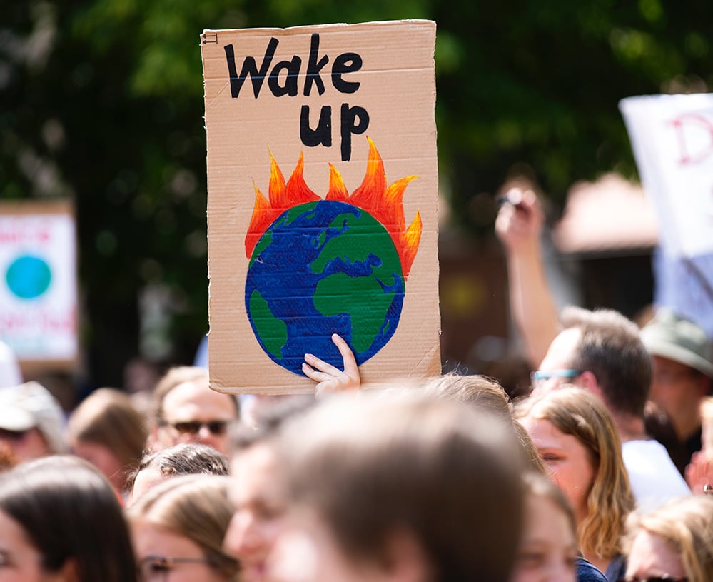 Image of a poster that says "Wake Up" at a Climate Strike protest.