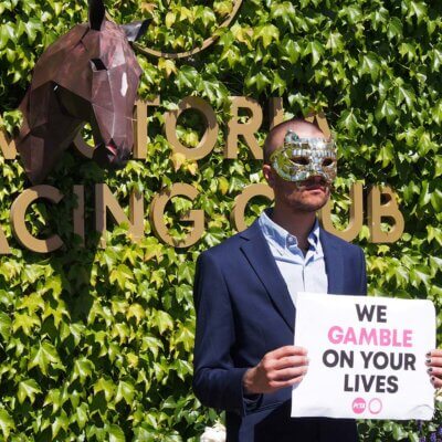 A protester wears the VIP mask from Squid Game